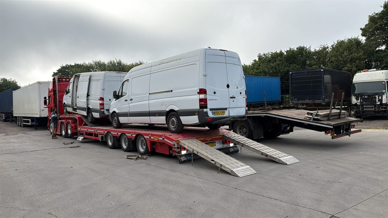 Two Sprinter vans loaded on a low-loader